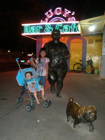 Posing with odd statues at Lucy's